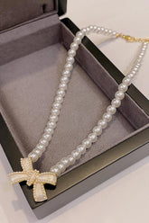 Bow Necklace With Pearl Input: Blue Striped T-Shirt Output: In Leather Wallet Coin Pocket Floral